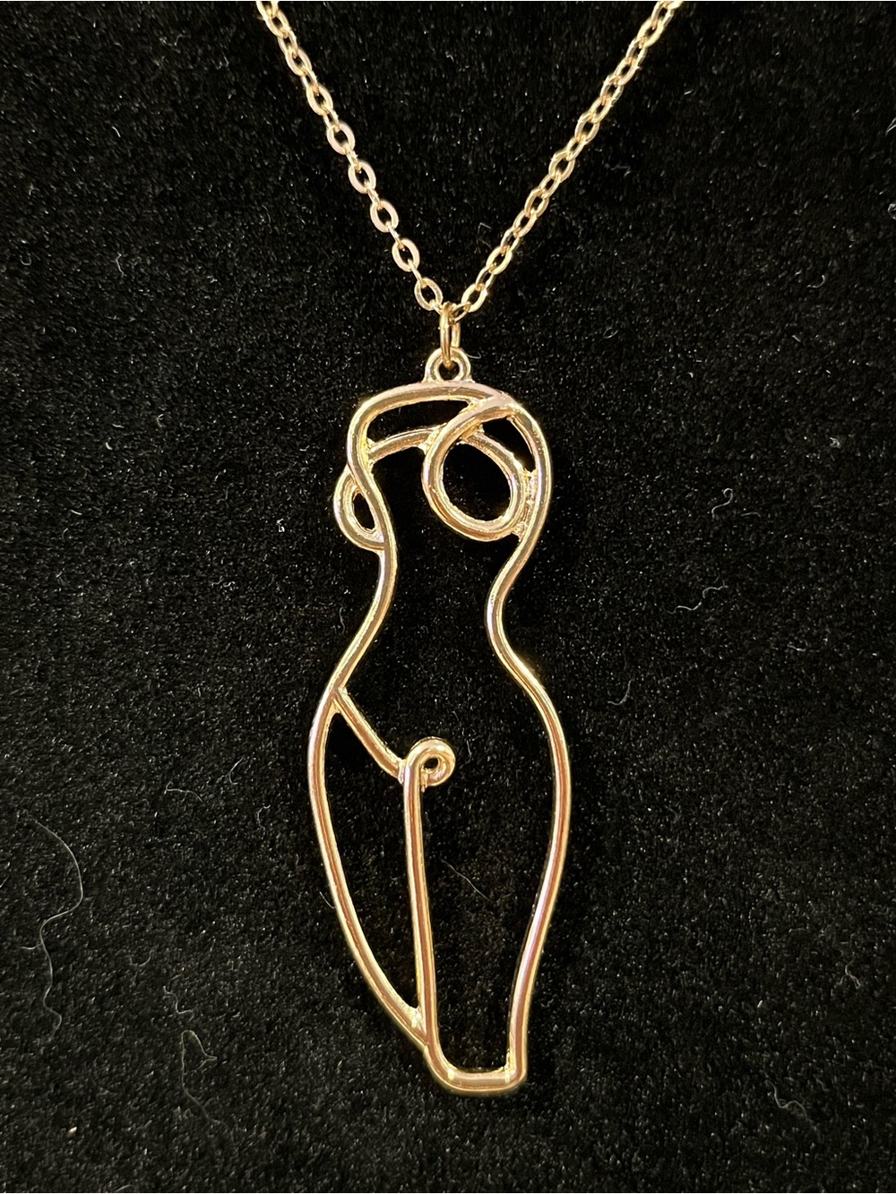 female form gold tone necklace